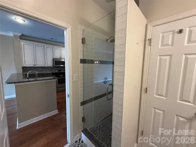 a kitchen with a refrigerator and a stove top oven