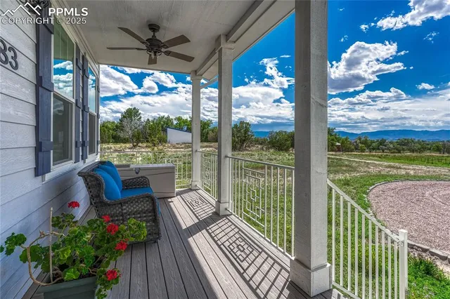 a balcony with furniture and garden view