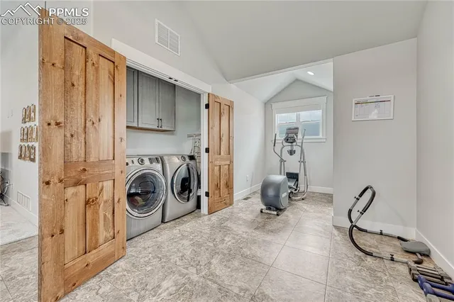 a room with gym equipment and a large mirror