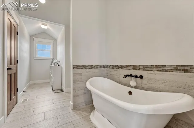 a white bath tub sitting next to a white sink