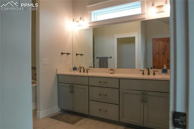 a bathroom with a double vanity sink and a mirror