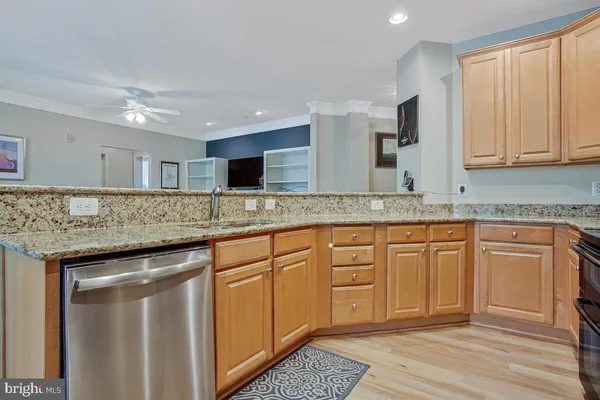 a kitchen with stainless steel appliances granite countertop a refrigerator stove and sink