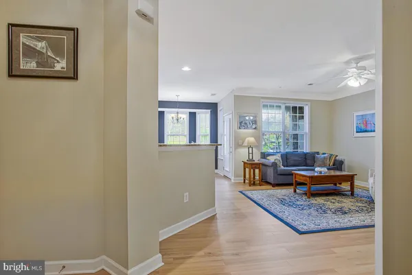 a view of a kitchen with wooden floor and cabinets