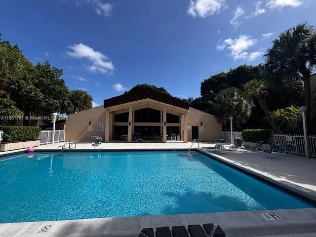 a view of a house with wooden fence