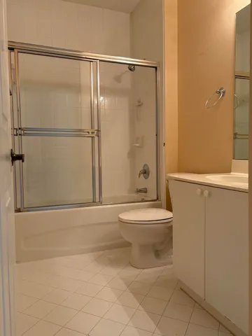 a bedroom with a bed and a night stand