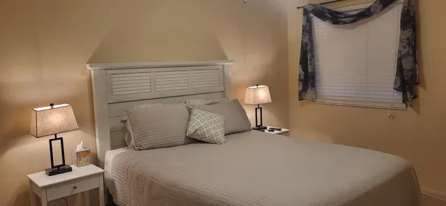 a bedroom with a bed and a mirror