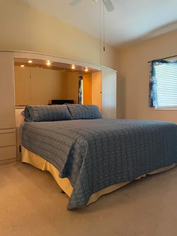 a bedroom with a bed and a window