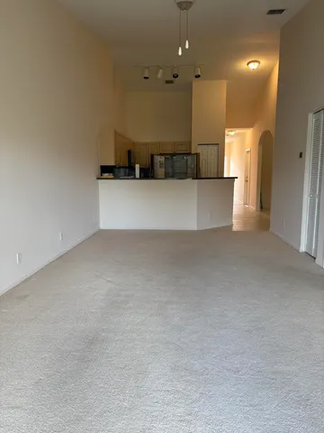 a view of a big room with a kitchen