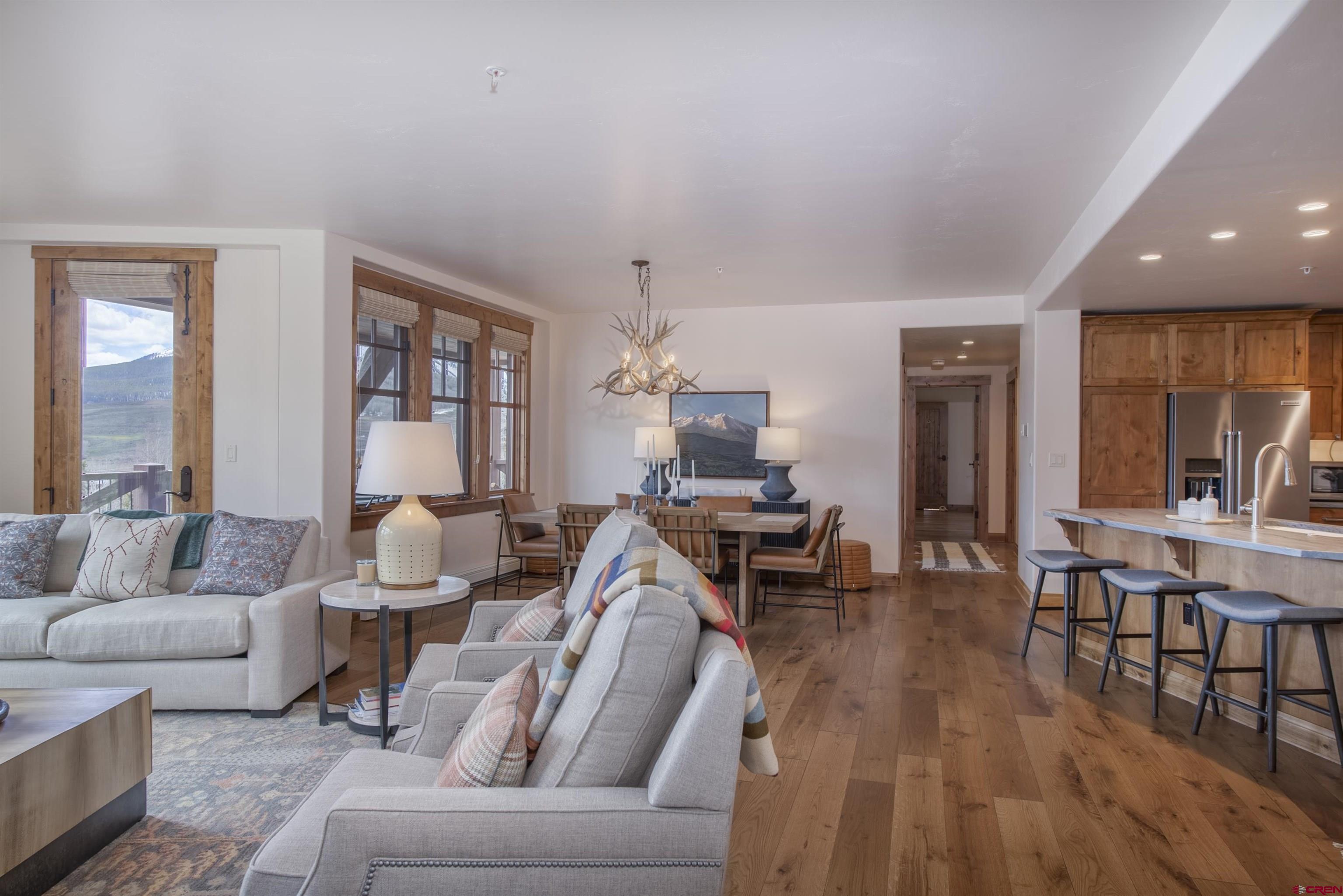 14 Hunter Hill Road, Unit C202 Crested Butte, CO 81225 - Photo 12 of 35 a living room with furniture dining table and a wooden floor