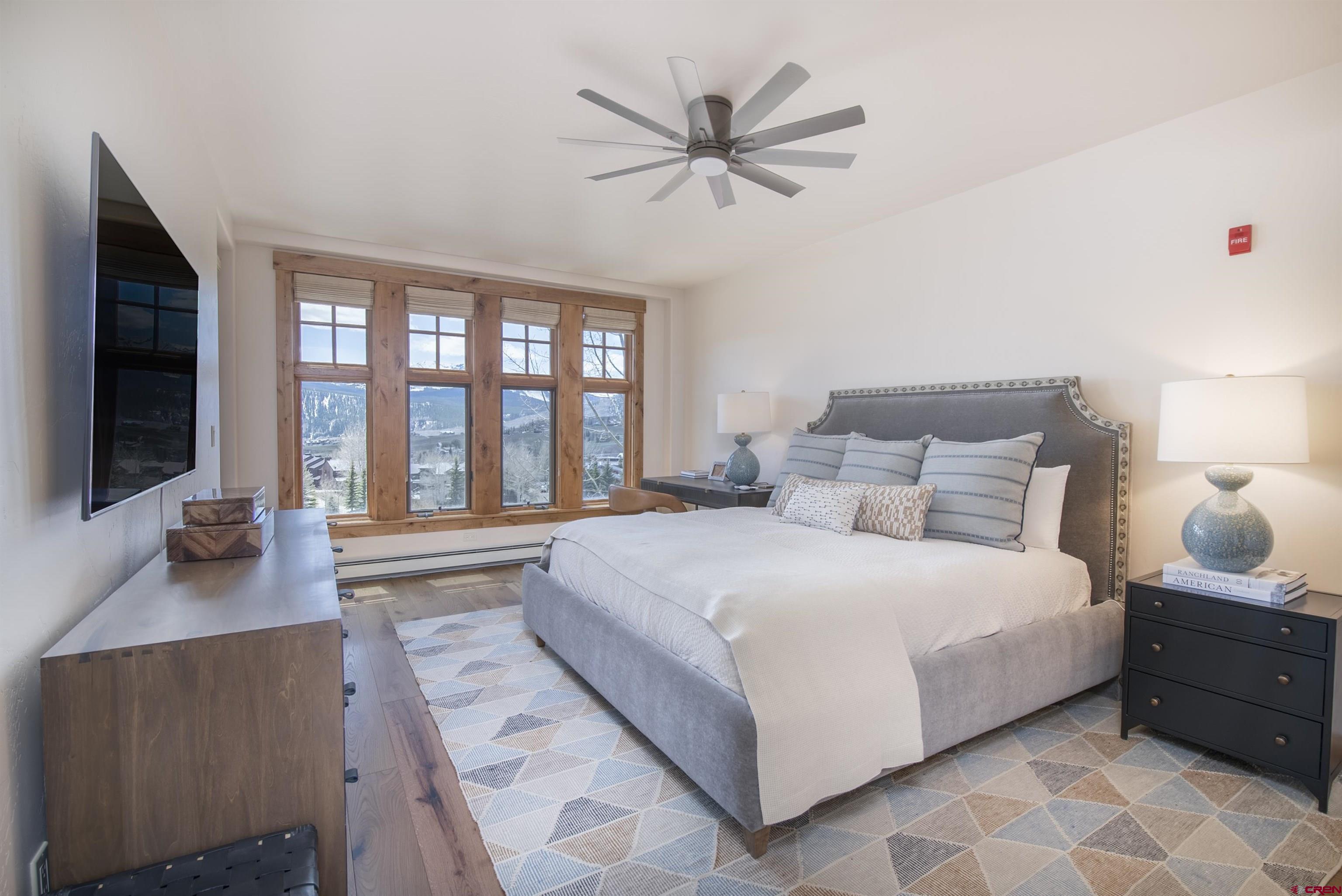 14 Hunter Hill Road, Unit C202 Crested Butte, CO 81225 - Photo 13 of 35 a bedroom with a large bed and a large window