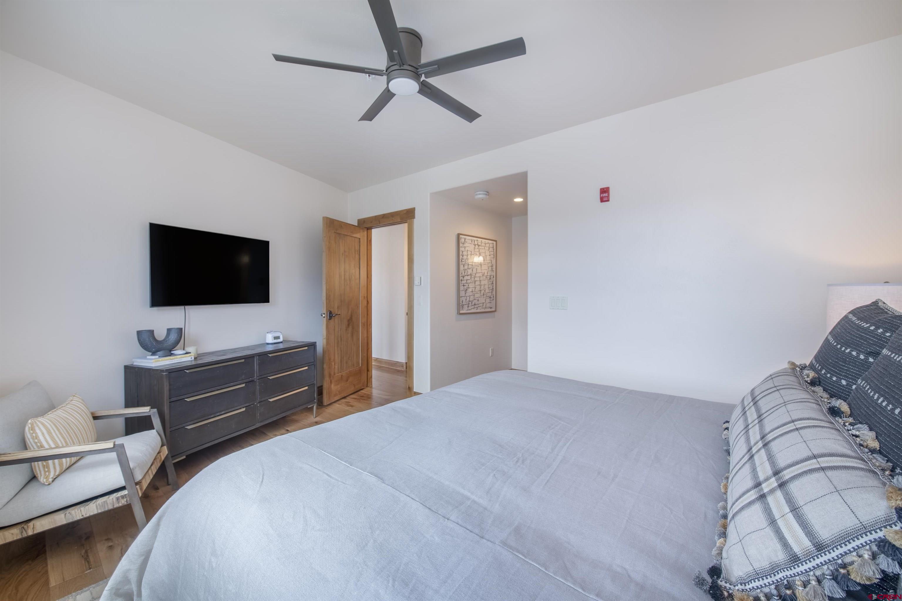 14 Hunter Hill Road, Unit C202 Crested Butte, CO 81225 - Photo 21 of 35 a bedroom with a bed and a flat screen tv