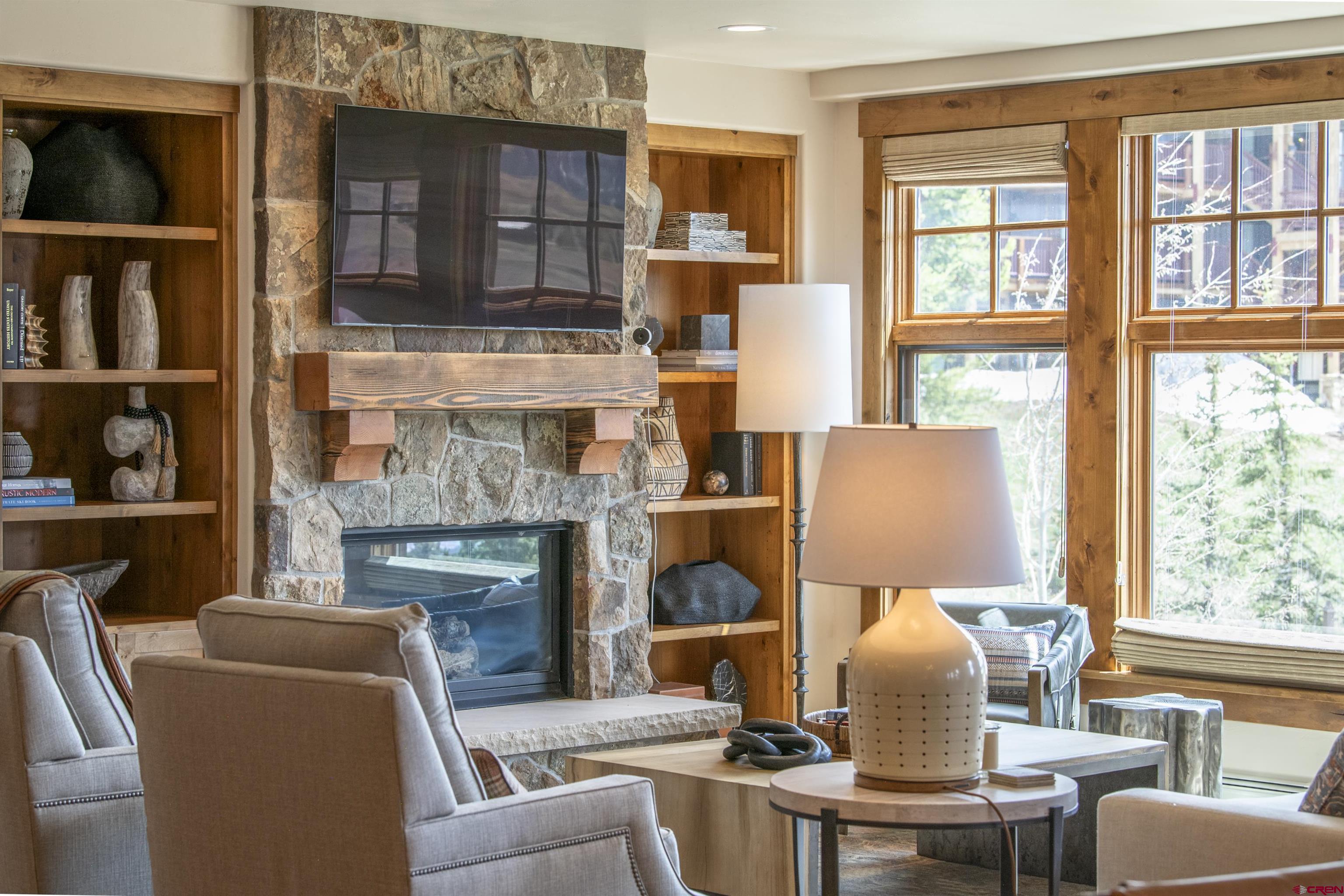 14 Hunter Hill Road, Unit C202 Crested Butte, CO 81225 - Photo 6 of 35 a living room with furniture and a fireplace