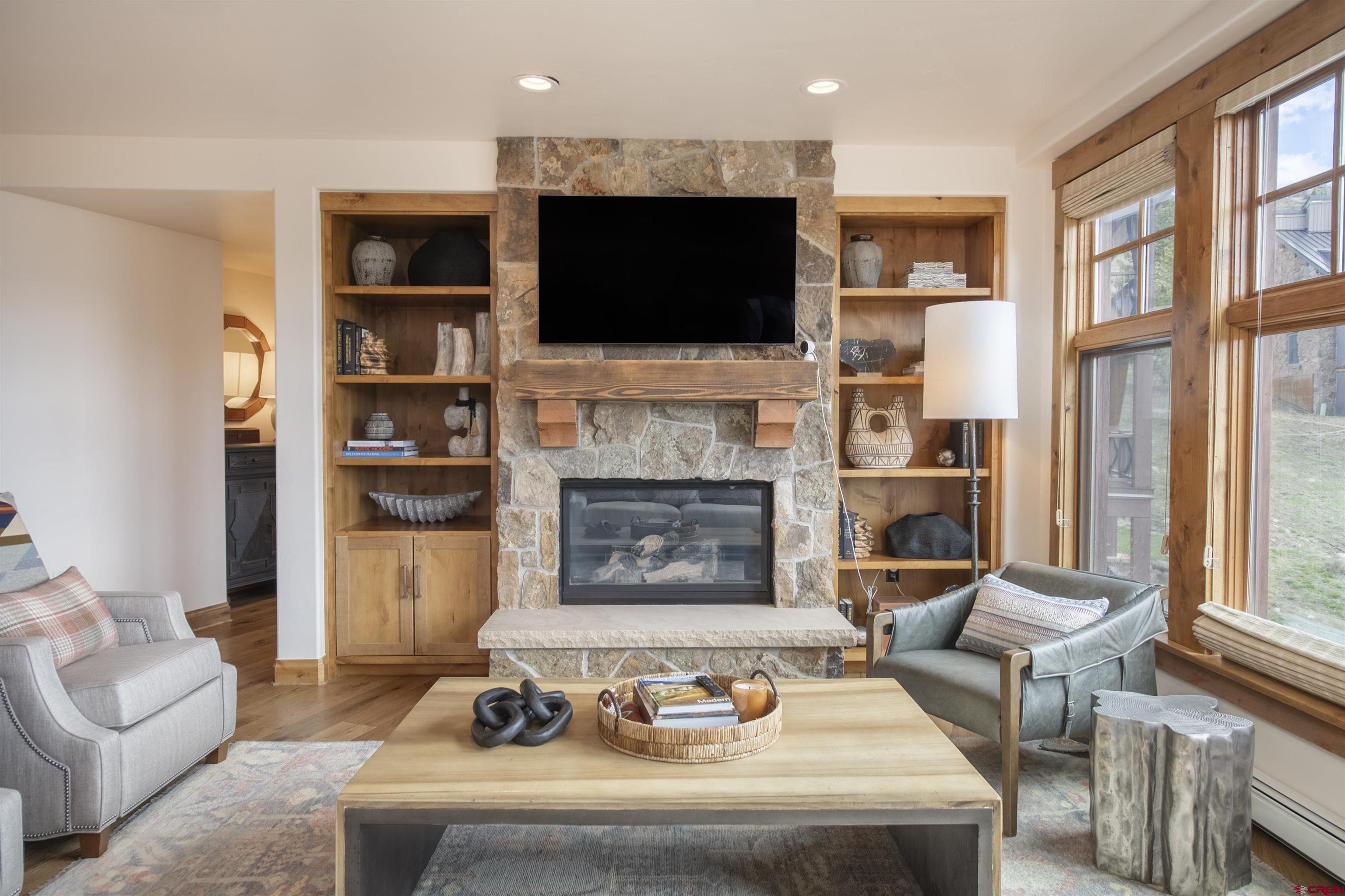 14 Hunter Hill Road, Unit C202 Crested Butte, CO 81225 - Photo 7 of 35 a living room with furniture a flat screen tv and a fireplace