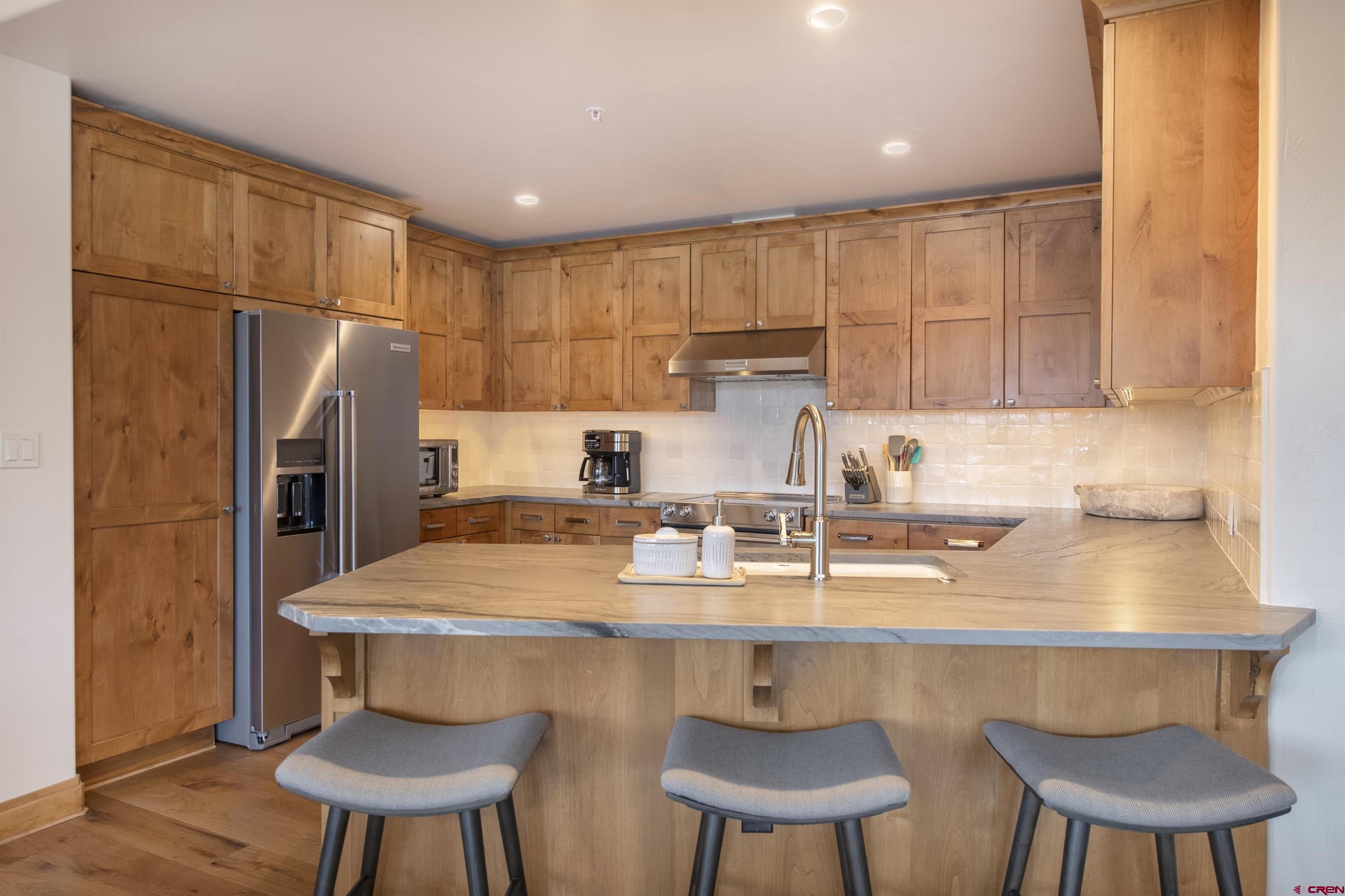 14 Hunter Hill Road, Unit C202 Crested Butte, CO 81225 - Photo 9 of 35 a kitchen with a sink a table and chairs