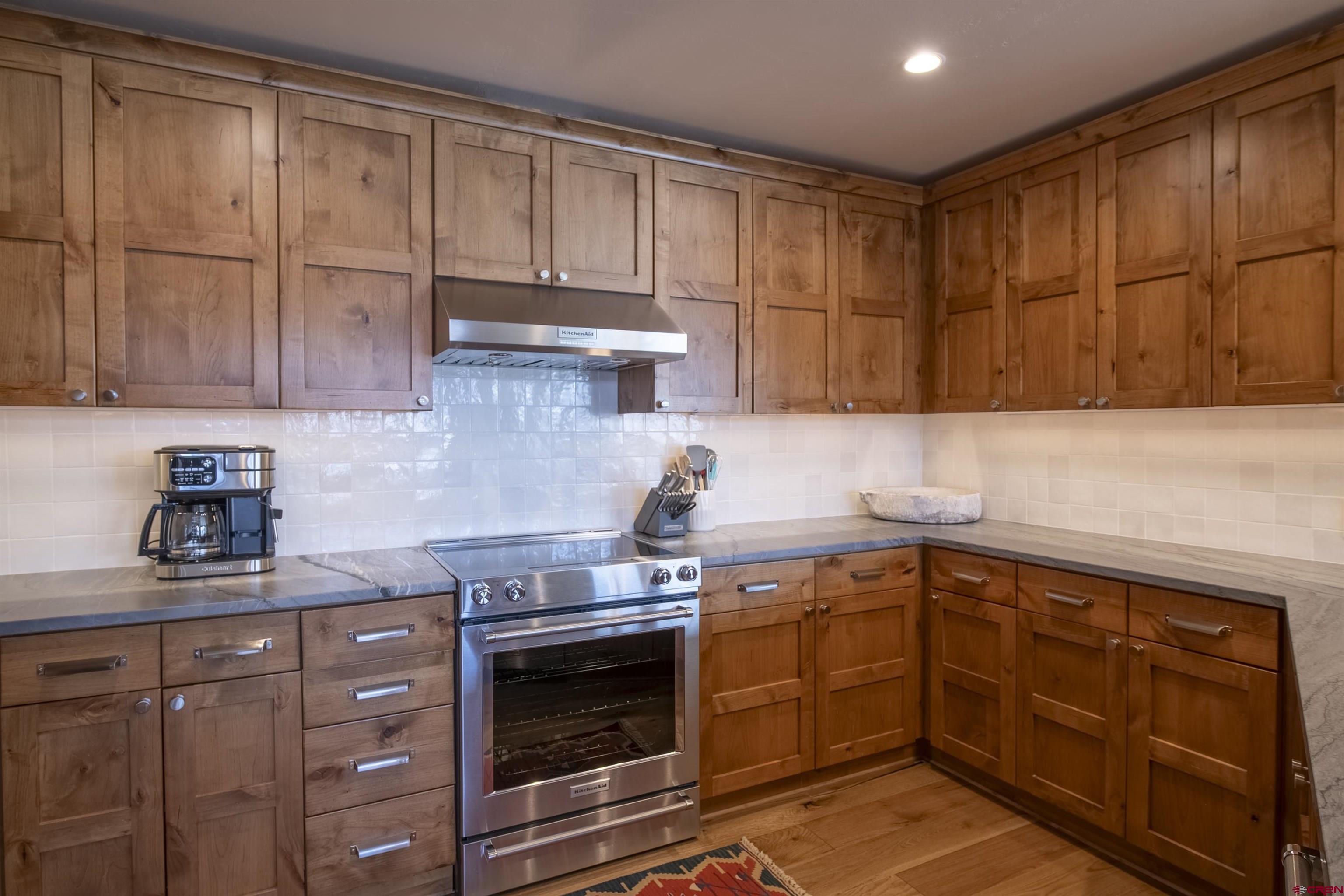 14 Hunter Hill Road, Unit C202 Crested Butte, CO 81225 - Photo 10 of 35 a kitchen with stainless steel appliances granite countertop a sink a stove and cabinets