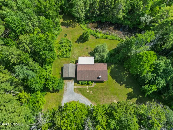 an aerial view of a house with a yard