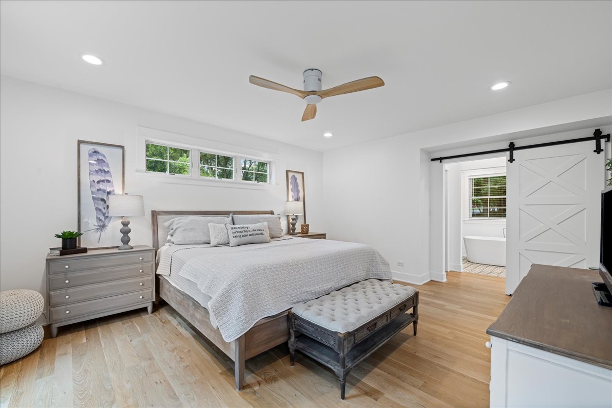 204 Country Commons Road Trout Valley, IL 60013 - Photo 18 of 58 a bedroom with a bed and a flat screen tv