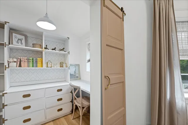 a room with lots of painting and a table