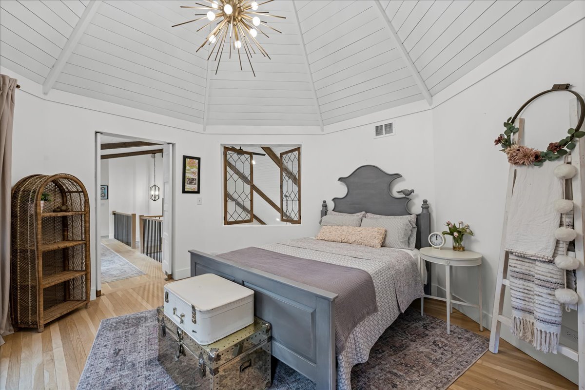 204 Country Commons Road Trout Valley, IL 60013 - Photo 23 of 58 a bedroom with a bed and a chandelier