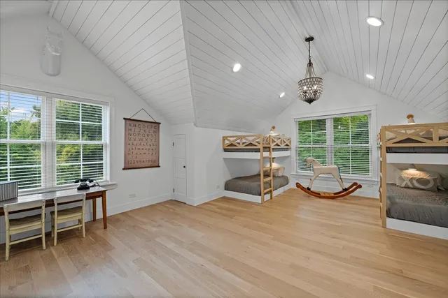 a living room with furniture a flat screen tv and a refrigerator