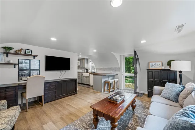 an aerial view of residential house with outdoor space and trees all around