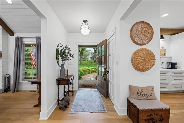 a view of a hallway with entryway wooden floor and a dining room