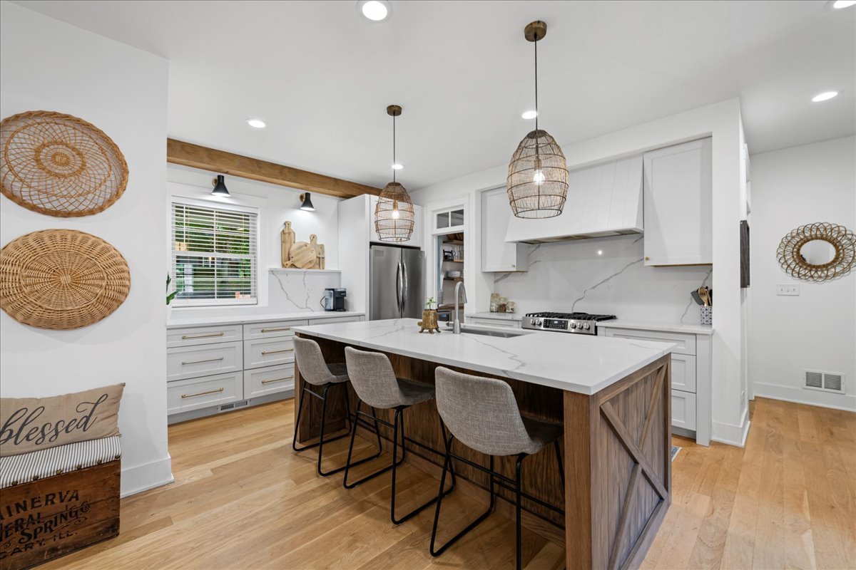 204 Country Commons Road Trout Valley, IL 60013 - Photo 7 of 58 a kitchen with granite countertop a stove a sink dishwasher a dining table and chairs with wooden floor
