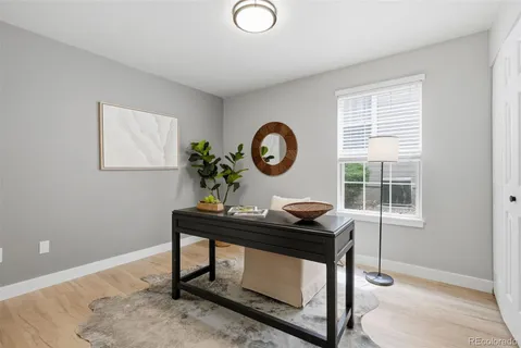a view of a workspace with furniture and a window
