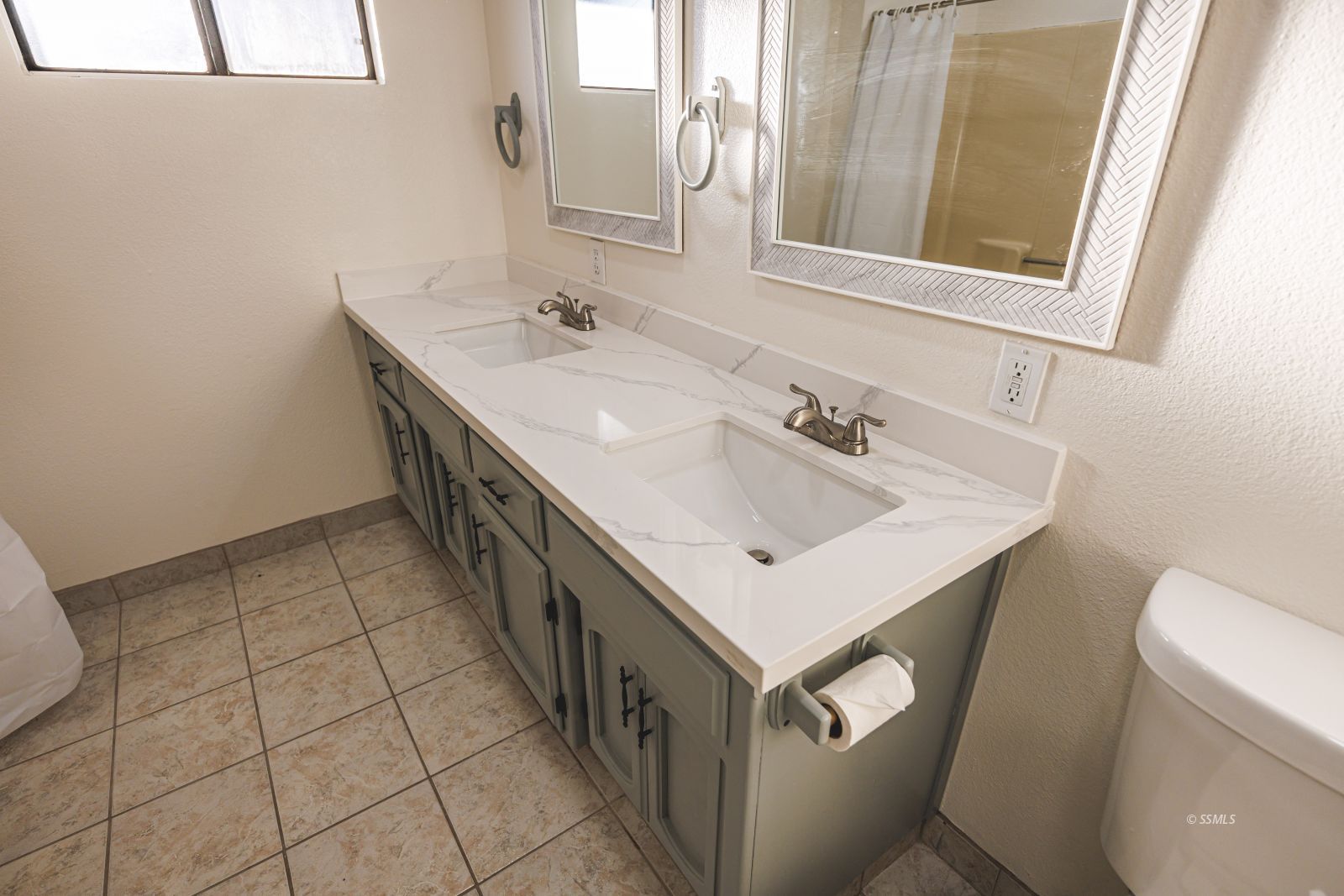 1213 Primrose Street Ridgecrest, CA 93555 - Photo 25 of 37 a bathroom with a sink a toilet and mirror