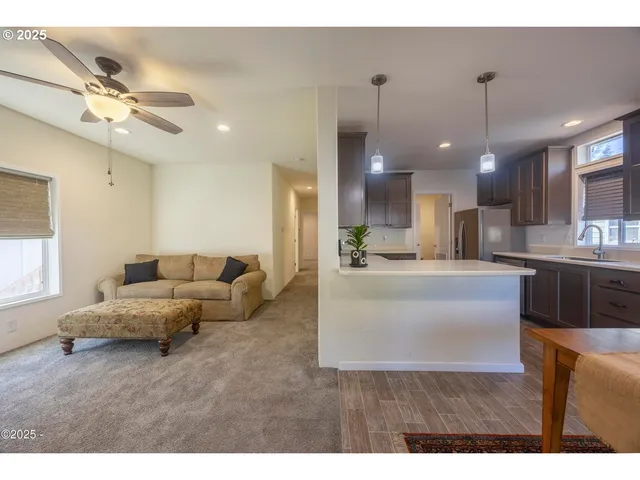 a living room with furniture and kitchen view