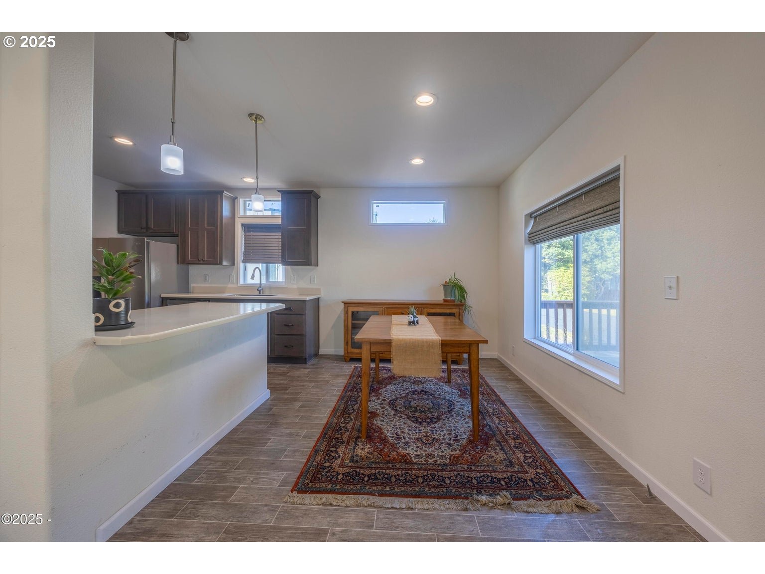 4875 Highway 101, Unit 3 Depoe Bay, OR 97341 - Photo 7 of 26 a living room with furniture a wooden floor and kitchen view