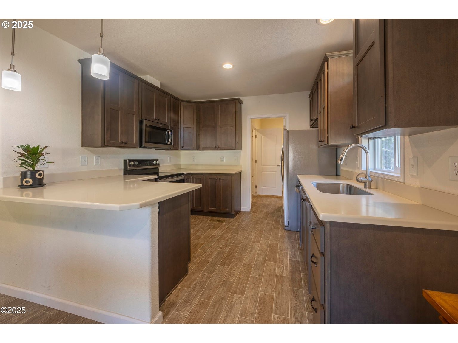 4875 Highway 101, Unit 3 Depoe Bay, OR 97341 - Photo 9 of 26 a kitchen with kitchen island a sink stainless steel appliances and cabinets