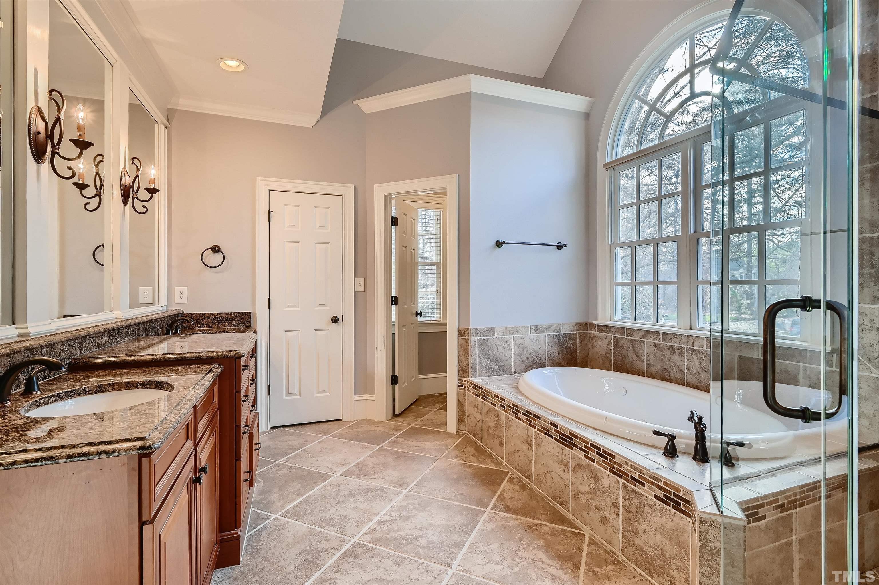 2714 Rosedale Avenue Raleigh, NC 27607 - Photo 17 of 28 a bathroom with a tub a sink and mirrors