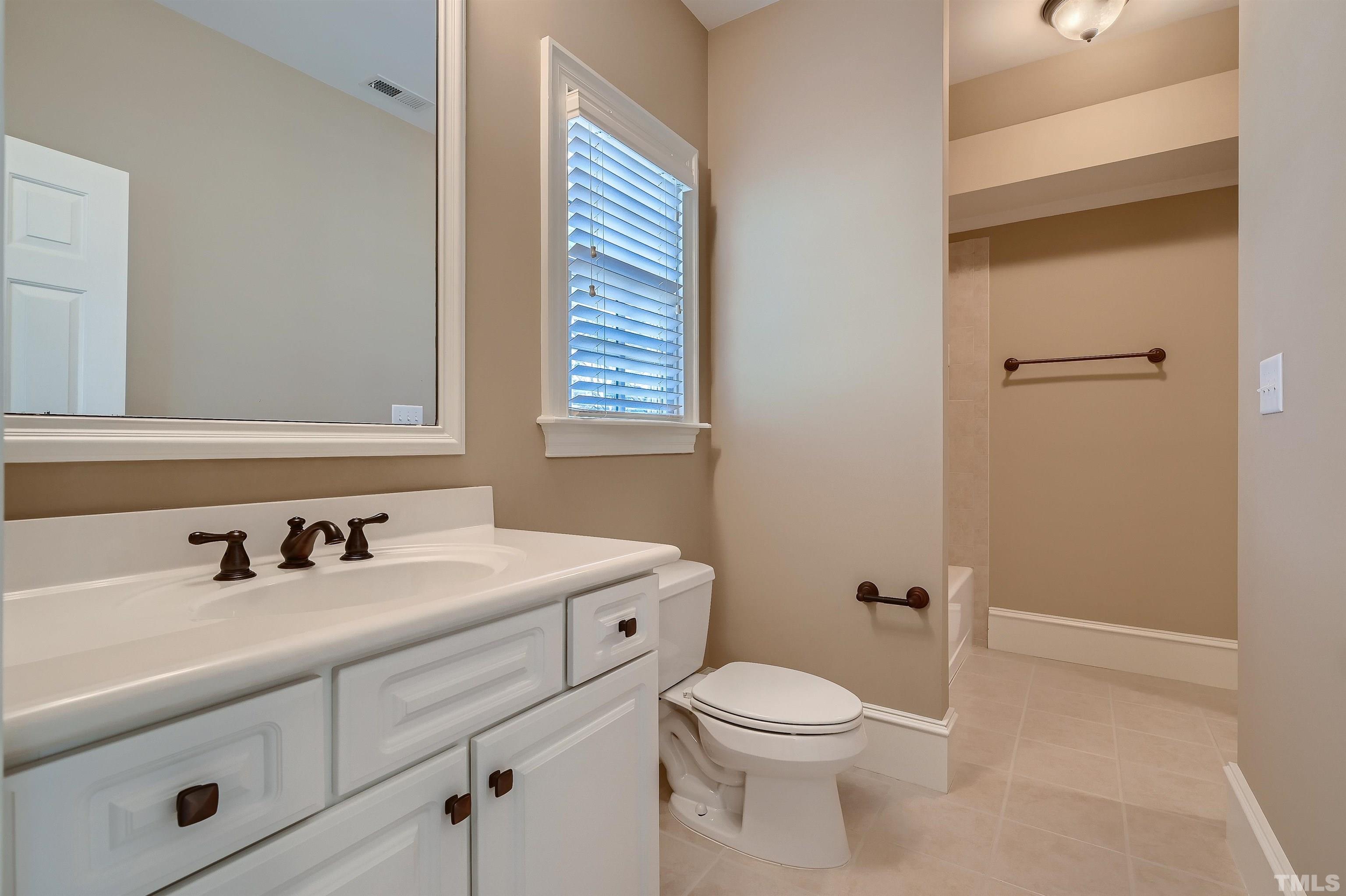 2714 Rosedale Avenue Raleigh, NC 27607 - Photo 23 of 28 a bathroom with a sink a toilet and a mirror