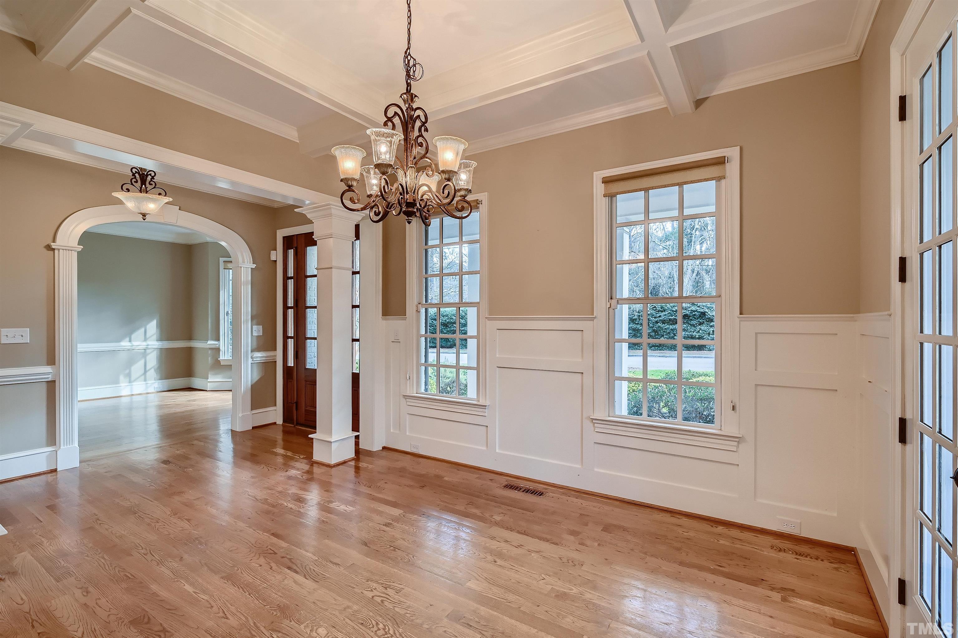 2714 Rosedale Avenue Raleigh, NC 27607 - Photo 7 of 28 an empty room with wooden floor chandelier and windows