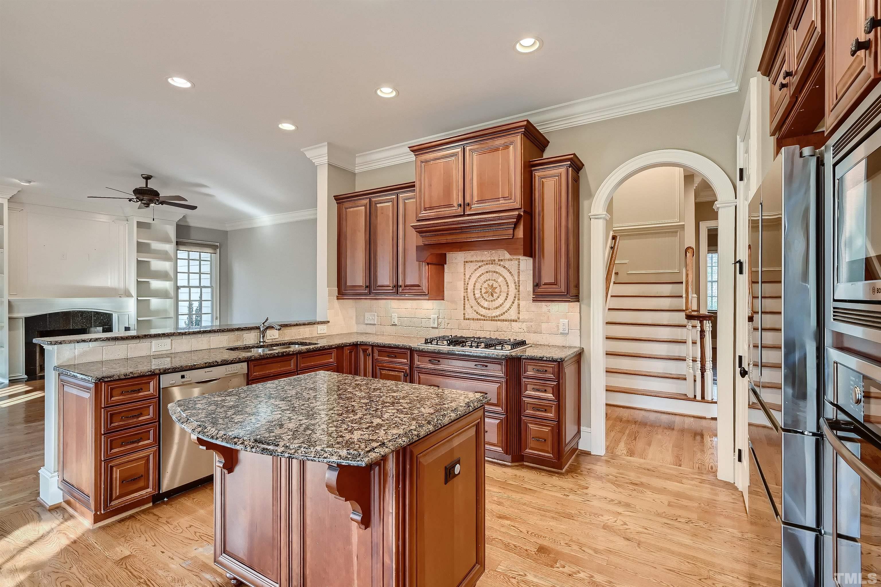 2714 Rosedale Avenue Raleigh, NC 27607 - Photo 8 of 28 a kitchen with stainless steel appliances granite countertop a stove and cabinets
