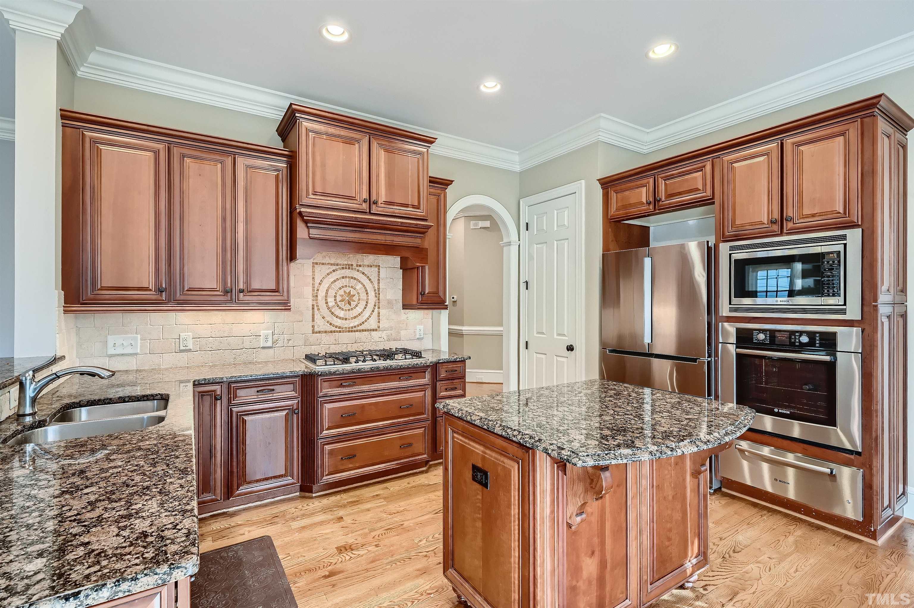 2714 Rosedale Avenue Raleigh, NC 27607 - Photo 10 of 28 a kitchen with stainless steel appliances granite countertop a stove refrigerator and cabinets