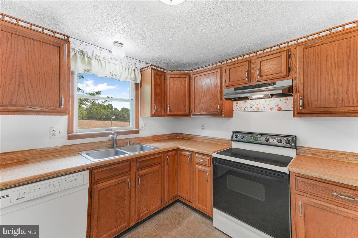 252 Althouse Road Cochranville, PA 19330 - Photo 13 of 28 a kitchen with a sink stove and microwave