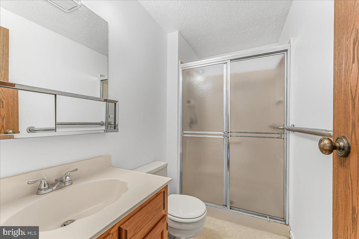 252 Althouse Road Cochranville, PA 19330 - Photo 18 of 28 a bathroom with a sink a toilet and shower