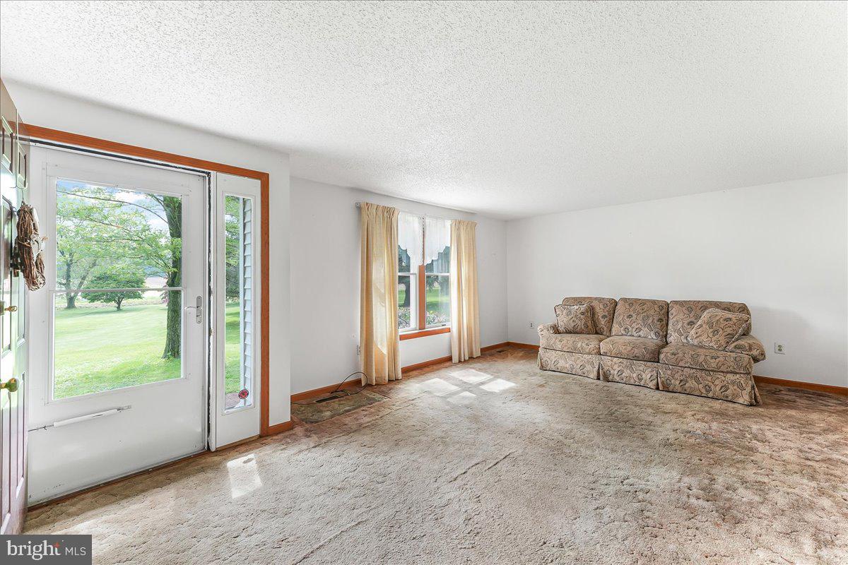 252 Althouse Road Cochranville, PA 19330 - Photo 6 of 28 a living room with furniture and a large window