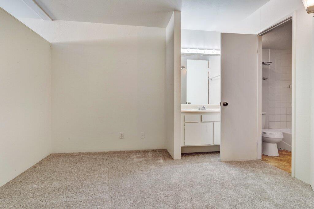 5300 East Waverly Drive, Unit 4209 Palm Springs, CA 92264 - Photo 6 of 13 an empty room and a bathroom with a sink