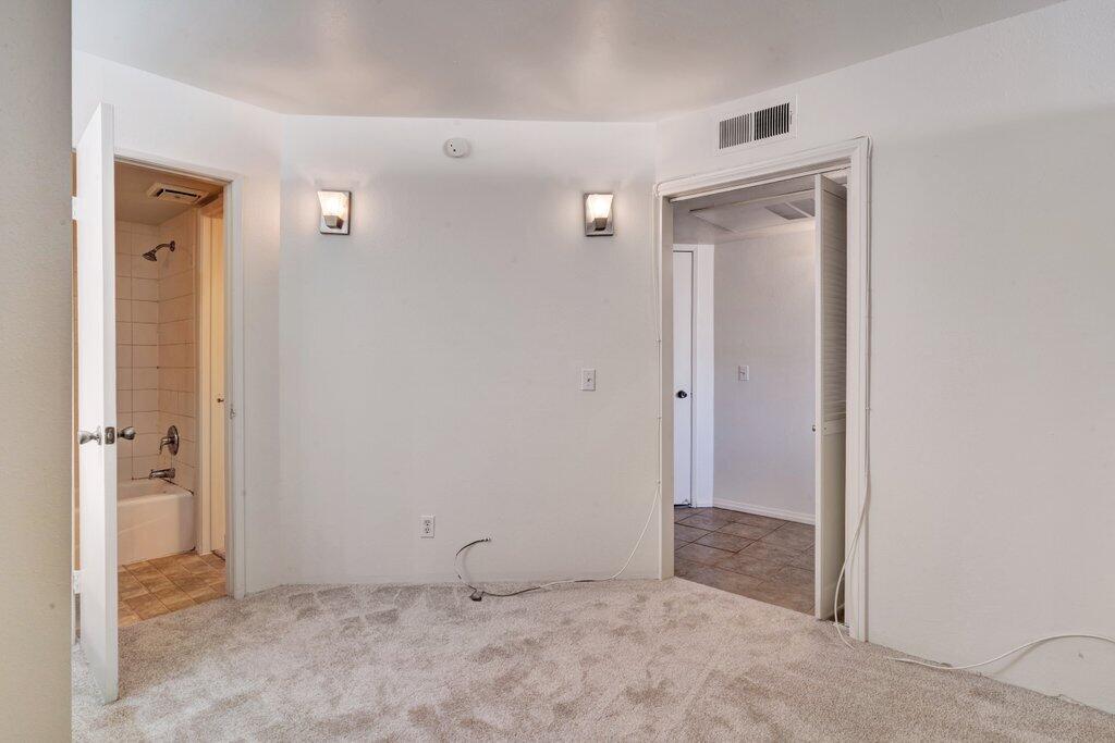 5300 East Waverly Drive, Unit 4209 Palm Springs, CA 92264 - Photo 7 of 13 an empty room with closet and a bathroom