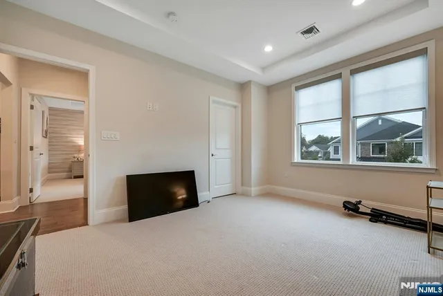 a dining room with furniture a chandelier and wooden floor