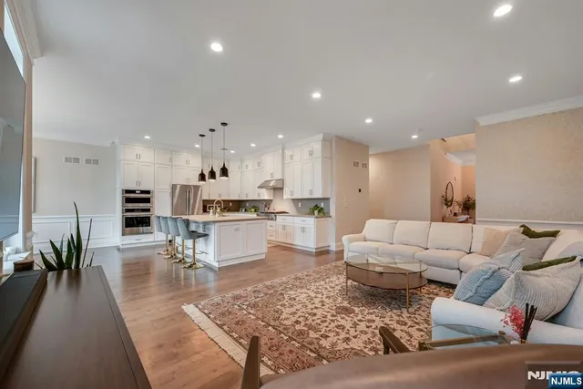 a kitchen with stainless steel appliances granite countertop a sink a stove and a refrigerator