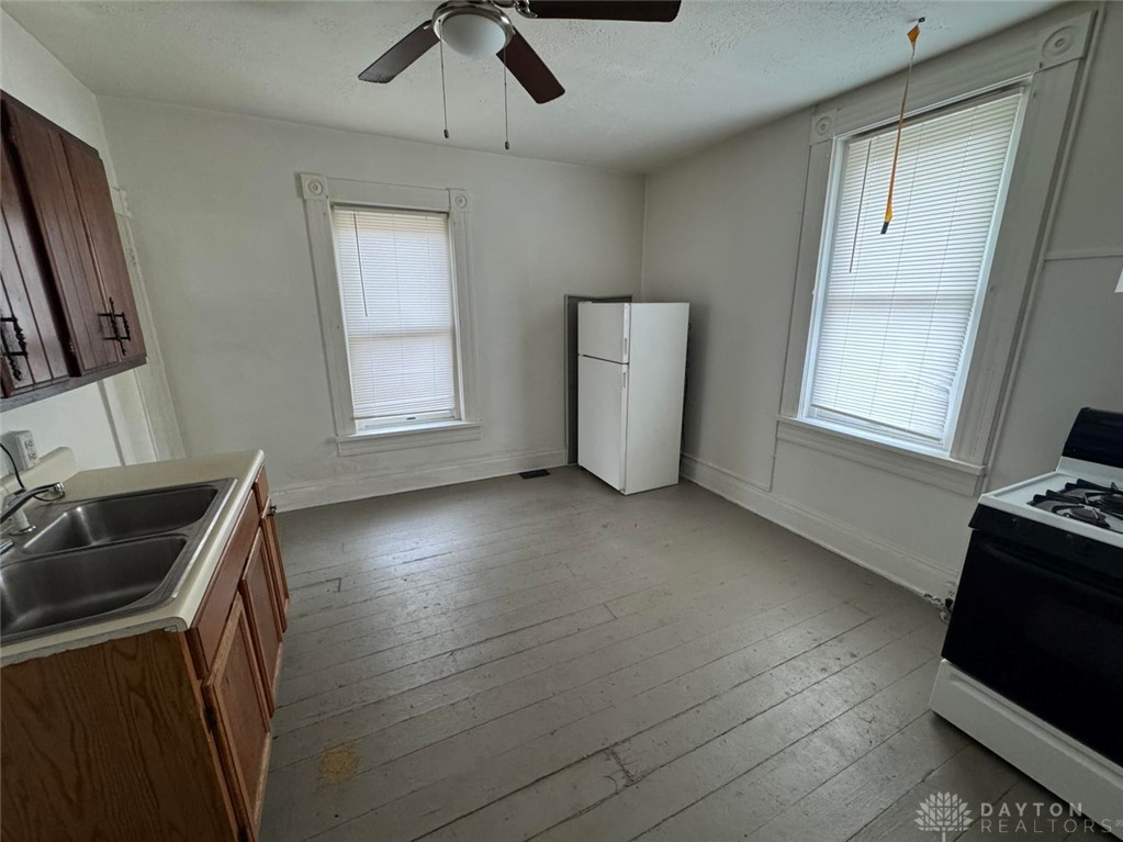 707 West High Street Springfield, OH 45506 - Photo 2 of 4 This spacious kitchen offers a functional layout with essential appliances and ample room for culinary endeavors.