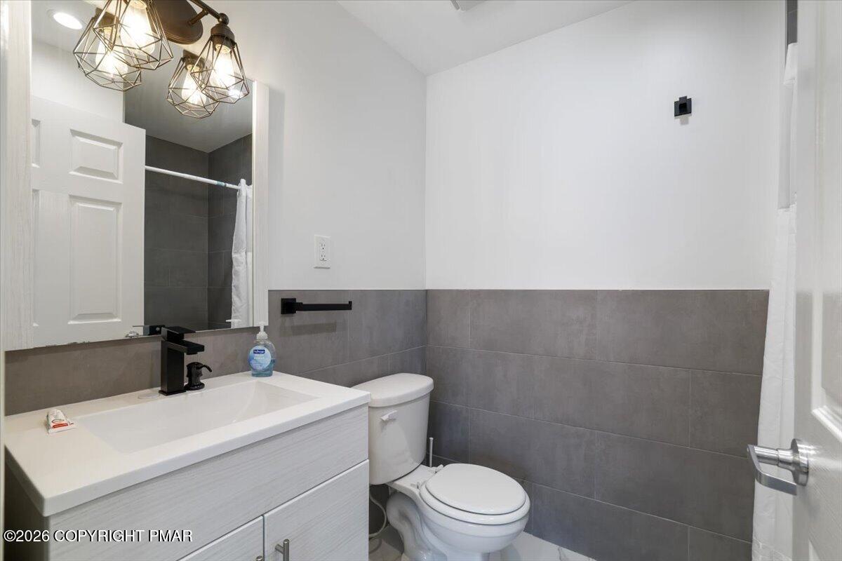 5873 Decker Road Bushkill, PA 18324 - Photo 16 of 57 a bathroom with a sink a toilet and a mirror