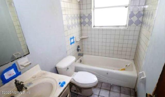 4104 Dayrl Road Jacksonville, FL 32207 - Photo 7 of 8 a white toilet sitting next to a bath tub