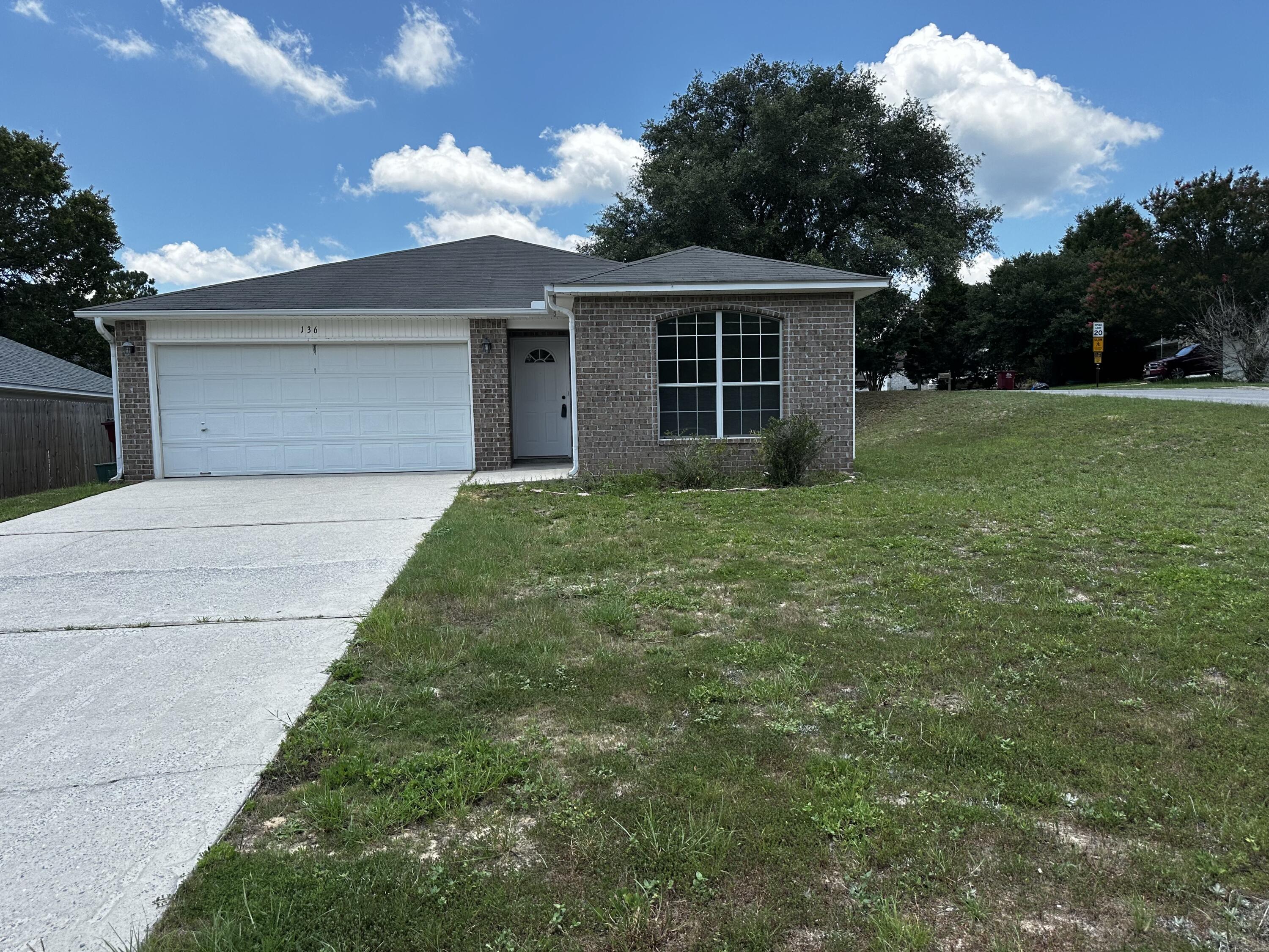136 Sandstone Trail Crestview, FL 32539 - Photo 1 of 17 a view of a house with a garden