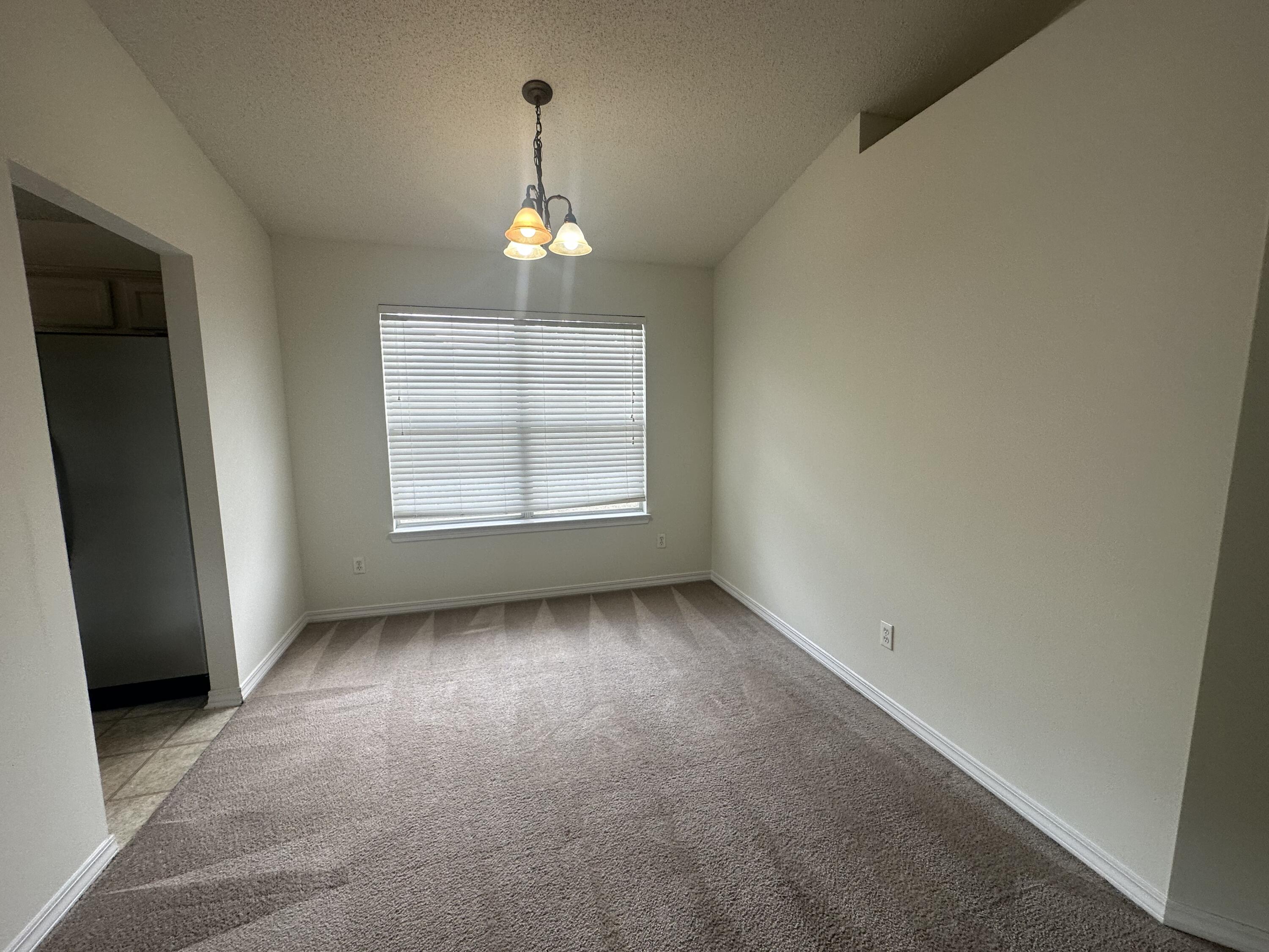 136 Sandstone Trail Crestview, FL 32539 - Photo 12 of 17 an empty room with windows and chandelier