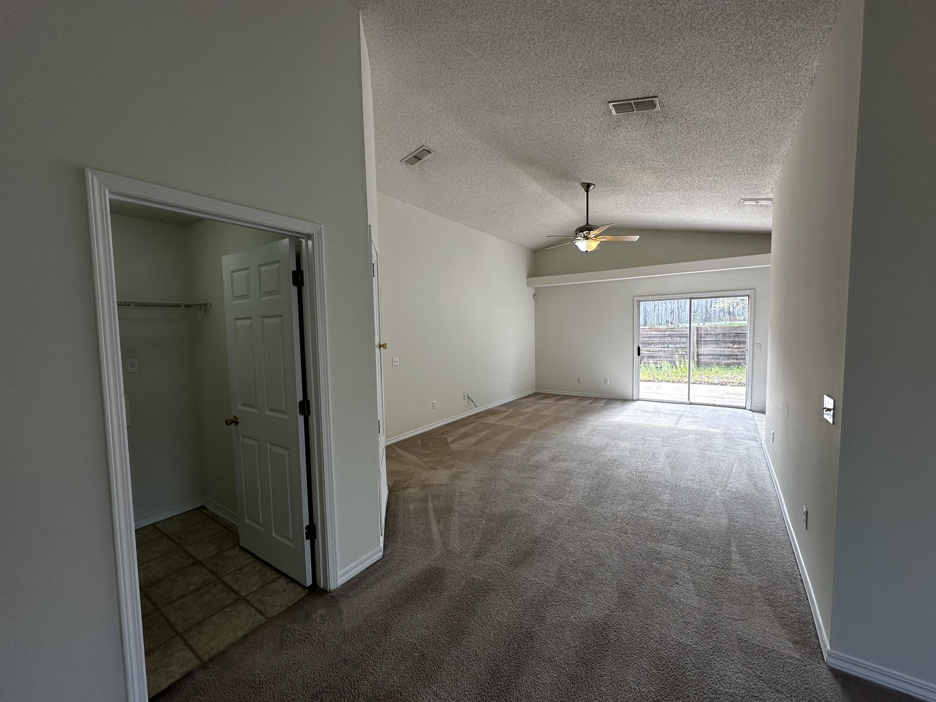 136 Sandstone Trail Crestview, FL 32539 - Photo 16 of 17 an empty room with windows and refrigerator